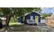 Charming blue home featuring a bright yellow door and a cozy front porch at 305 E Adalee St, Tampa, FL 33603