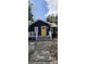 Charming home featuring a blue exterior, yellow door, and welcoming front porch at 305 E Adalee St, Tampa, FL 33603