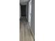 Hallway with refinished hardwood floors and updated grey paint at 305 E Adalee St, Tampa, FL 33603