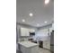 Updated kitchen featuring granite countertops, stainless appliances, and white cabinetry at 305 E Adalee St, Tampa, FL 33603