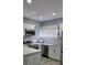 Updated kitchen featuring granite countertops, stainless appliances, and white cabinetry at 305 E Adalee St, Tampa, FL 33603