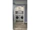 Convenient laundry room featuring a side-by-side washer and dryer and storage cabinets at 305 E Adalee St, Tampa, FL 33603