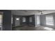 Bright living room with refinished hardwood floors, ceiling fans, and plenty of natural light at 305 E Adalee St, Tampa, FL 33603