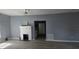 Open-concept living room featuring a fireplace, refinished floors, and a view into the kitchen at 305 E Adalee St, Tampa, FL 33603