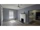 Living room featuring a fireplace, refinished floors, and a view into the kitchen at 305 E Adalee St, Tampa, FL 33603