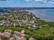 Beautiful aerial shot of tan townhomes situated near a tranquil bay and lush greenery at 3077 Branch Dr, Clearwater, FL 33760
