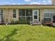 View of a screened in back patio with a door and an air conditioning unit at 3077 Branch Dr, Clearwater, FL 33760