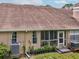View of the back of the house, including the screened-in porch, windows, and yard at 3077 Branch Dr, Clearwater, FL 33760