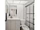 Modern bathroom with white vanity, framed mirror, toilet, and walk-in shower with black hardware at 3077 Branch Dr, Clearwater, FL 33760