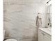 Bathroom features white marble-look tiling, white vanity, and towel rack at 3077 Branch Dr, Clearwater, FL 33760