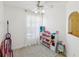 Bright bedroom features natural light, white walls, and a decorative ceiling fan at 3077 Branch Dr, Clearwater, FL 33760