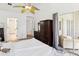 Bedroom features a decorative ceiling fan, closet with sliding doors, and plenty of natural light at 3077 Branch Dr, Clearwater, FL 33760