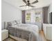Cozy bedroom boasts a ceiling fan, natural light and neutral decor at 3077 Branch Dr, Clearwater, FL 33760