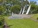 The community sign for Seabrooke sits on green grass near a lake at 3077 Branch Dr, Clearwater, FL 33760