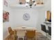 Cozy dining area with stylish chandelier, seating for four, and view to the upstairs balcony at 3077 Branch Dr, Clearwater, FL 33760