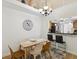 Cozy dining area with stylish chandelier, seating for four, and view to the kitchen breakfast bar at 3077 Branch Dr, Clearwater, FL 33760