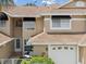 Charming home exterior with a well-maintained lawn, two-car garage, and classic architectural details at 3077 Branch Dr, Clearwater, FL 33760