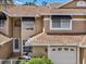 Charming home exterior with a well-maintained lawn, two-car garage, and classic architectural details at 3077 Branch Dr, Clearwater, FL 33760