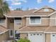 Charming home exterior with a well-maintained lawn, two-car garage, and classic architectural details at 3077 Branch Dr, Clearwater, FL 33760