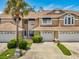 Charming multi-level townhome with attached garages, mature palm tree and meticulously maintained landscaping at 3077 Branch Dr, Clearwater, FL 33760
