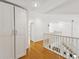 Hallway features hardwood floors, white walls, and an open stairwell at 3077 Branch Dr, Clearwater, FL 33760