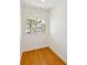 Bright hallway nook with hardwood floors and an arched window with neighborhood views at 3077 Branch Dr, Clearwater, FL 33760
