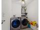 Functional laundry room featuring modern washer and dryer, ample lighting and storage at 3077 Branch Dr, Clearwater, FL 33760
