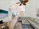 Bright and spacious living room with vaulted ceiling, laminate flooring, and view of stairs and kitchen at 3077 Branch Dr, Clearwater, FL 33760