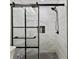 Sleek, modern walk-in shower with white marble tiling, black hardware, and tile flooring at 3077 Branch Dr, Clearwater, FL 33760