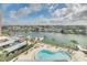 Stunning aerial view showcasing the waterfront condos, boat docks, and pool with bay views, highlighting the prime location at 31 Island Way # 502, Clearwater Beach, FL 33767
