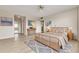 Relaxing bedroom with natural light, wood floors, ceiling fan and blue accent rug at 31 Island Way # 502, Clearwater Beach, FL 33767