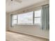 Bedroom with wood-look flooring, ceiling fan, and large windows with blue curtains at 31 Island Way # 502, Clearwater Beach, FL 33767