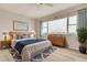 Bright bedroom features wood floors, a ceiling fan, and a scenic window view at 31 Island Way # 502, Clearwater Beach, FL 33767