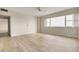 Spacious bedroom offers wood-look floors, a ceiling fan, and expansive windows at 31 Island Way # 502, Clearwater Beach, FL 33767