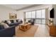 Cozy living room with large window, comfortable seating, and warm, natural light at 31 Island Way # 502, Clearwater Beach, FL 33767