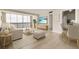 Bright living room with large windows offering beautiful views, modern furniture, and light wood flooring at 31 Island Way # 502, Clearwater Beach, FL 33767