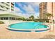 Beautiful outdoor pool with shallow end and poolside seating, providing a refreshing oasis for residents to unwind and socialize at 31 Island Way # 502, Clearwater Beach, FL 33767