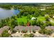 Aerial shot of townhome complex surrounded by mature trees, a lake, and well-manicured lawns at 3519 Heards Ferry Dr, Tampa, FL 33618