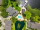 An aerial view of an expansive backyard featuring a pool, dock, and peaceful lake providing the ideal retreat at 3519 Heards Ferry Dr, Tampa, FL 33618