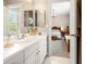 Clean bathroom featuring a white vanity with dual mirrors and an open doorway to a bedroom at 3519 Heards Ferry Dr, Tampa, FL 33618