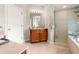 Bathroom featuring a wood vanity, a glass-enclosed shower, and a white door at 3519 Heards Ferry Dr, Tampa, FL 33618