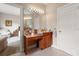 Bathroom featuring a wood vanity and a large mirror with bright lights at 3519 Heards Ferry Dr, Tampa, FL 33618
