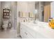 Bright bathroom featuring a white vanity, large mirror, storage shelf, and shower with tub at 3519 Heards Ferry Dr, Tampa, FL 33618
