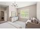 Bright bedroom featuring a large window, comfortable seating area, and a stylish chandelier at 3519 Heards Ferry Dr, Tampa, FL 33618