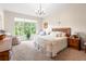 Cozy bedroom features a wooden bed frame, a large window with lots of natural light, and comfortable seating at 3519 Heards Ferry Dr, Tampa, FL 33618
