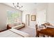 Sunlit bedroom features neutral walls, a wooden desk, a window with blinds, and a comfortable daybed at 3519 Heards Ferry Dr, Tampa, FL 33618