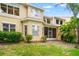 A tan two-story home with manicured lawn and tropical landscaping at 3519 Heards Ferry Dr, Tampa, FL 33618