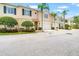Attractive townhome showcases a two-car garage, manicured landscaping, and lovely palm trees at 3519 Heards Ferry Dr, Tampa, FL 33618