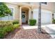Inviting front entrance featuring a white door, a decorative wreath, and lush landscaping at 3519 Heards Ferry Dr, Tampa, FL 33618