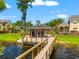 Tranquil view of an outdoor gazebo with a fireplace located on a dock overlooking the peaceful waterfront at 3519 Heards Ferry Dr, Tampa, FL 33618